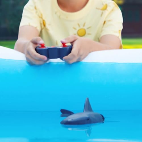 Child playing with Terra by Battat remote control shark in a pool