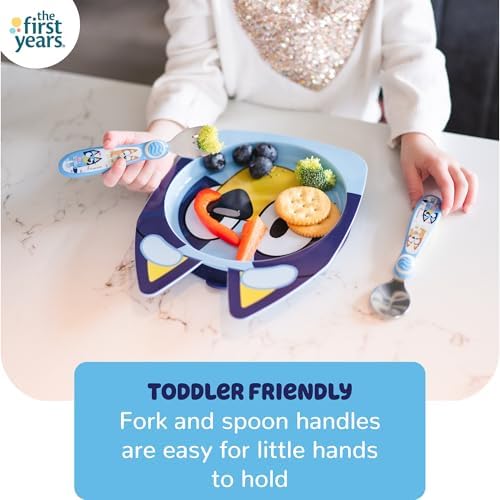 Toddler using Bluey dinnerware set at table