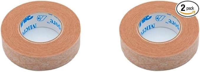 Close up view of 3M beige hypoallergenic paper tape rolls showing the breathable non-woven texture.