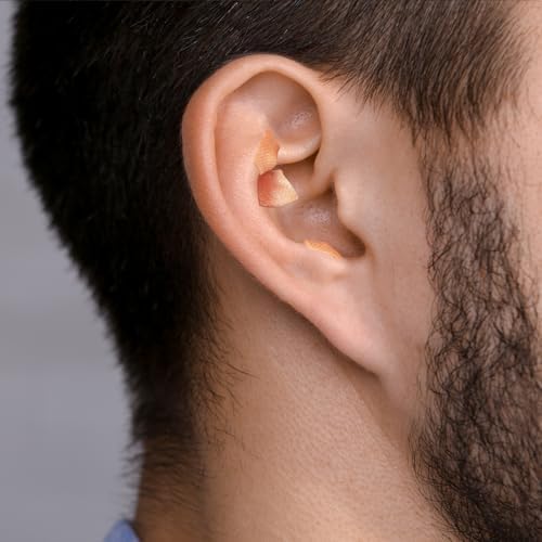 Close up of magnetic ear seeds on adhesive backing for stress relief