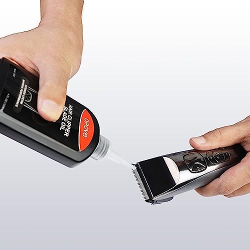 Close up of the included black cleaning brushes removing hair debris from hair styling clipper blades