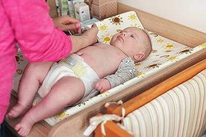 Bohemian theme crescent moon and star patterned microfiber sheet stretched on a baby changing mat.