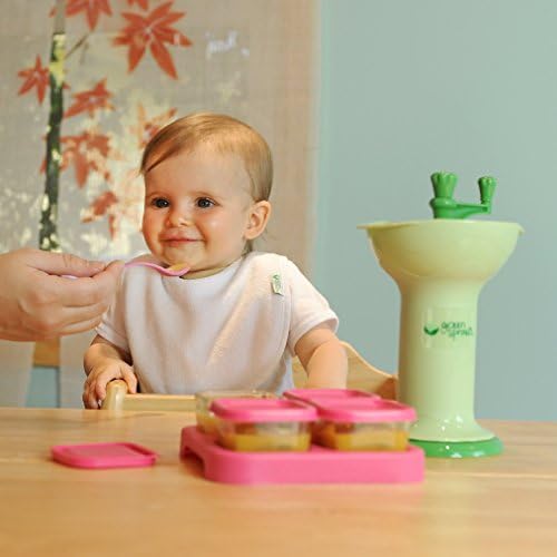 Green Sprouts baby food grinder with cooked vegetables inside the grinding chamber.