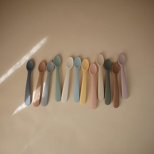 Two pack of Mushie food-grade silicone baby weaning cutlery displayed on a neutral background.
