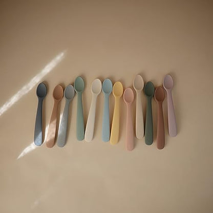 Two pack of Mushie food-grade silicone baby weaning cutlery displayed on a neutral background.