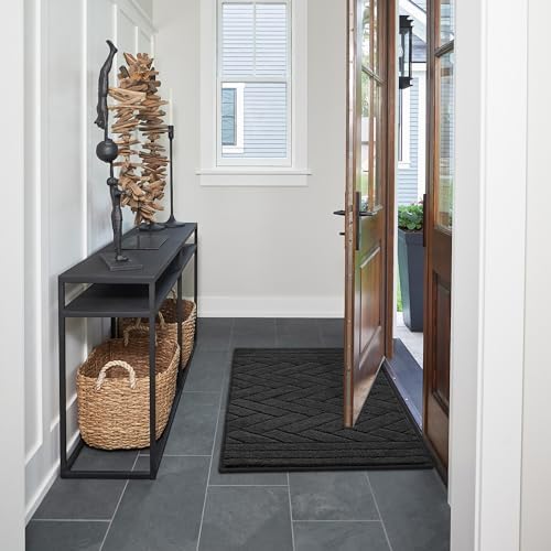 Washable mud mat for dogs being placed inside a home washing machine.