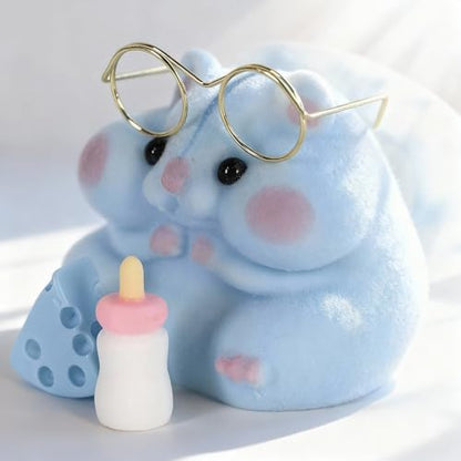 Handmade Taba hamster squishy toy next to its miniature feeding bottle accessory.