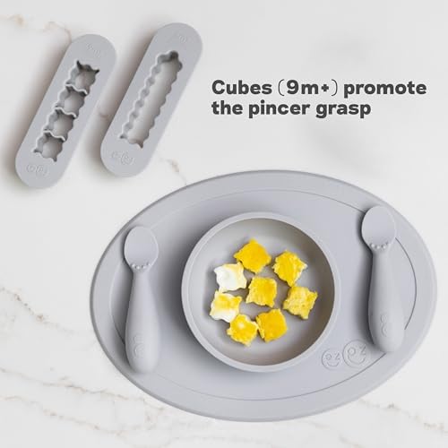 Ezpz baby food cutters next to fresh produce