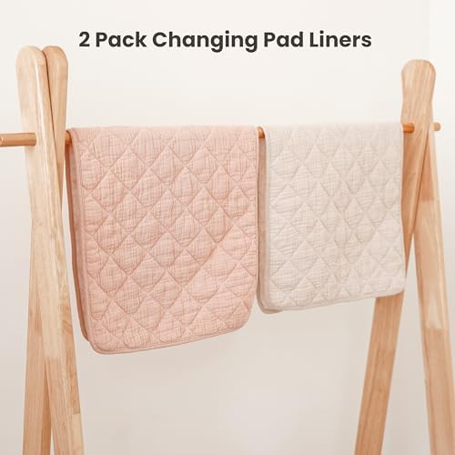 Konssy quilted baby changing mat in use on a bed