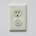 Dreambaby electrical safety plug covers in living room setting