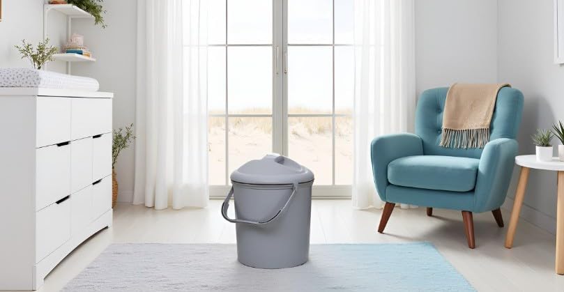 Rotho Babydesign Bella Bambina Nappy Pail placed next to nursery changing station