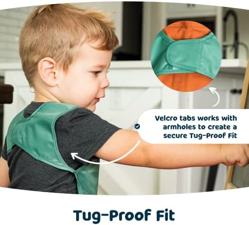 Durable recycled polyester toddler smock being rinsed clean under tap water.