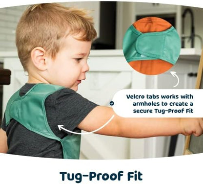 Durable recycled polyester toddler smock being rinsed clean under tap water.