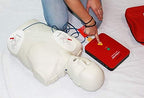 Lifesaver AED trainer 4-pack showing accessories and included AA batteries.