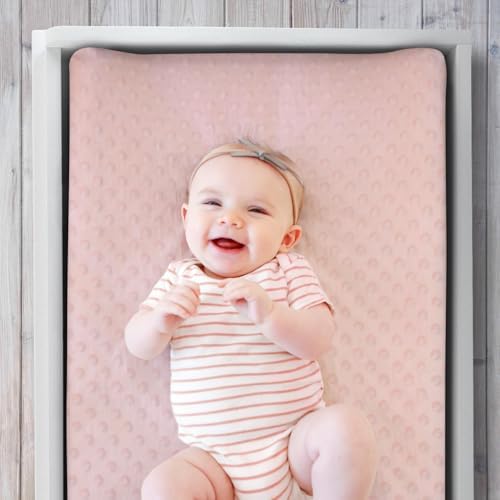 Close-up view of the plush minky dot fabric on the pink nursery sheet.