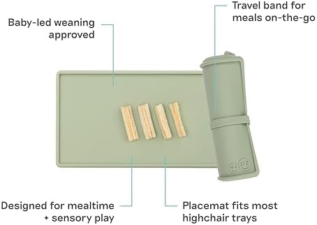 Ezpz infant suction mat rolled up compactly with its matching green travel band.