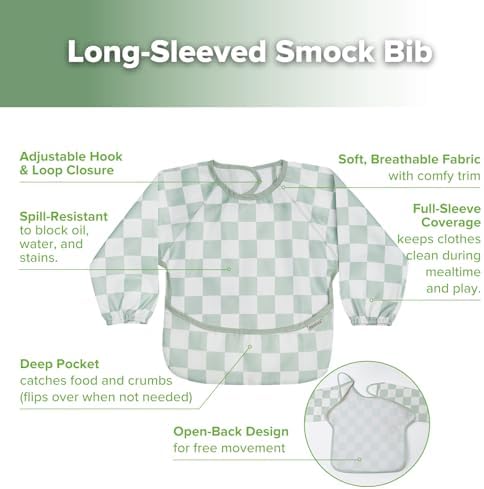 Haakaa water resistant toddler art smock being wiped clean with a cloth