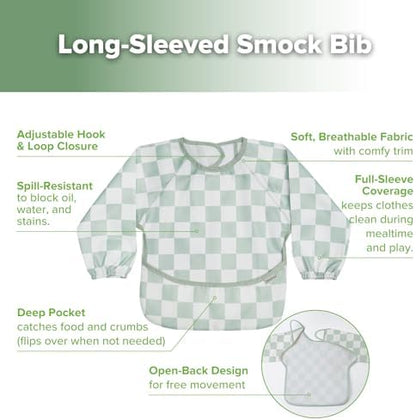 Haakaa water resistant toddler art smock being wiped clean with a cloth