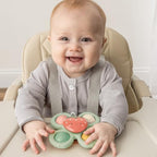 Itzy Ritzy strawberry infant travel toy showing the bottom suction cup base designed for smooth tables and highchairs.