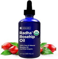 Radha Beauty Organic Rosehip Seed Oil front view of blue bottle with dropper.