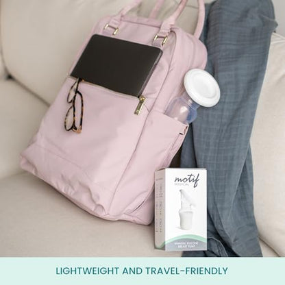 Motif Medical four ounce silicone breast pump compact design next to diaper bag