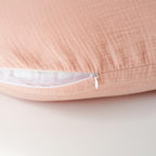 Konssy nursing pillow slipcover being placed on a standard feeding pillow