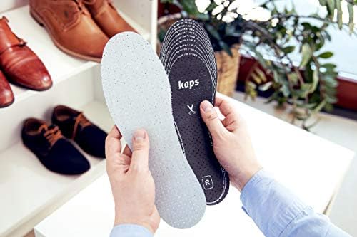 Kaps shoe inserts being trimmed with scissors for perfect fit