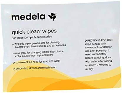 Medela portable accessory wipes being used to clean a baby high chair surface