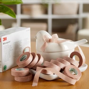 Side angle view of two half inch wide 3M Micropore tan surgical tapes for sensitive skin.