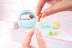 Close up of the detailed miniature diaper caddy and bear tub accessories from the series.