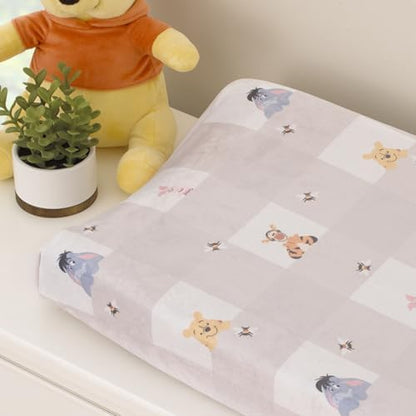 Close up view of the soft buffalo check fabric featuring printed Disney characters.