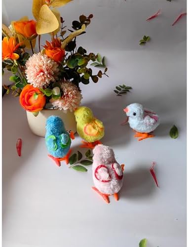 Fluffy white bunny and yellow chick jumping toys moving on a flat floor surface
