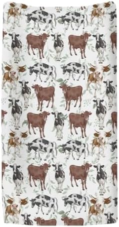 Close up of watercolor cow and green leaf nursery fabric pattern