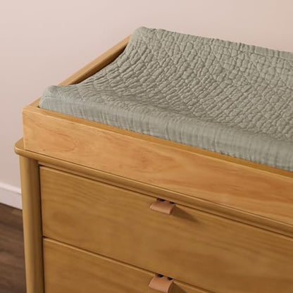 Close-up of GOTS-certified organic cotton muslin fabric weave on baby changing cover