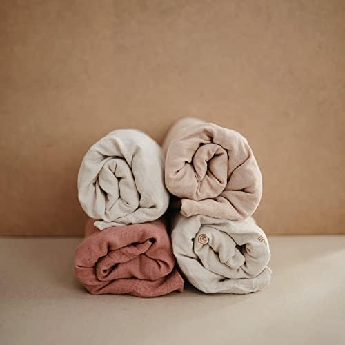 Close up look of the breathable cotton texture on the Mushie Fog changing pad cover