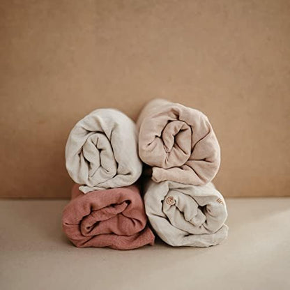 Close up look of the breathable cotton texture on the Mushie Fog changing pad cover