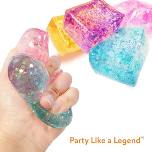 An adult hand squeezing the flexible pink glitter cube for stress relief