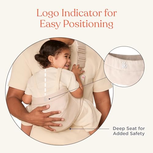 Ergobaby natural beige baby carrier with essentials placed inside the front storage pocket.