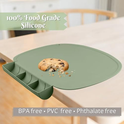 Olive green non slip kids eating mat rolled up tightly for portable travel storage.