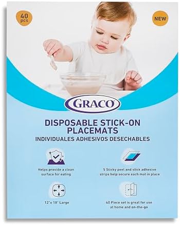 Graco baby disposable table cover folded compactly next to a diaper bag for travel.
