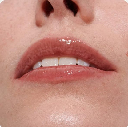 Rhode Peptide Lip Tint Toast shade tube next to its minimalist cardboard box.