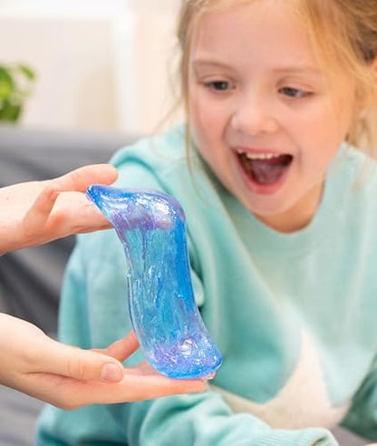 Crystal clear blue transparent silicone putty being stretched out from its metal container.