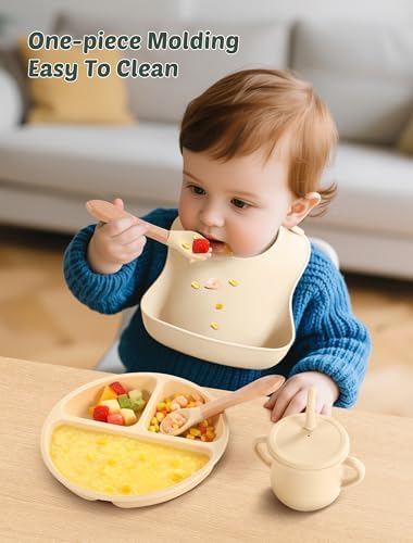 Baby eating independently with silicone feeding supplies