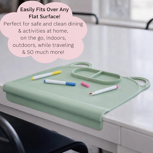 A toddler using the blue Domensi suction mat as a non-slip crafting station while playing with colorful clay.