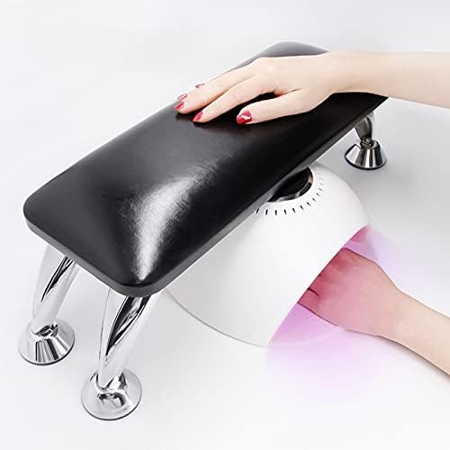 Nail technician using arm rest with nail lamp placed underneath