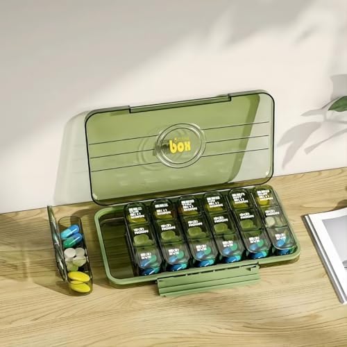 Open medicine organizer showing removable tray and internal compartments
