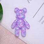 Aesnefe miniature worry bear held in palm showcasing pocket size portability.