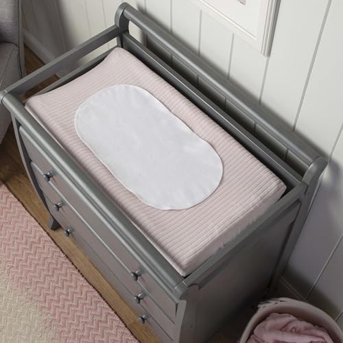 Boppy changing pad liner placed on standard nursery changing table