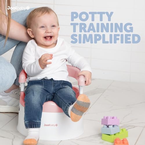 Toddler using Jool Baby pink potty chair with handles