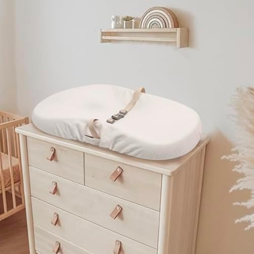 Waterproof backing demonstration of the Pikpops white nursery changing pad sheet.